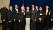 Rep. Cheri Bustos (D-IL-17th), center, with IP Newton Jones, fourth from left; IVP Larry McManamon, sixth from left; IR Bill Staggs, third from right; and l. to r., Brandon Ragland, L-363; Ben Kosiek, L-1; Lew Moceri, L-363; Kirk Cooper, L-60; and Glenn Reinhardt, L-483.